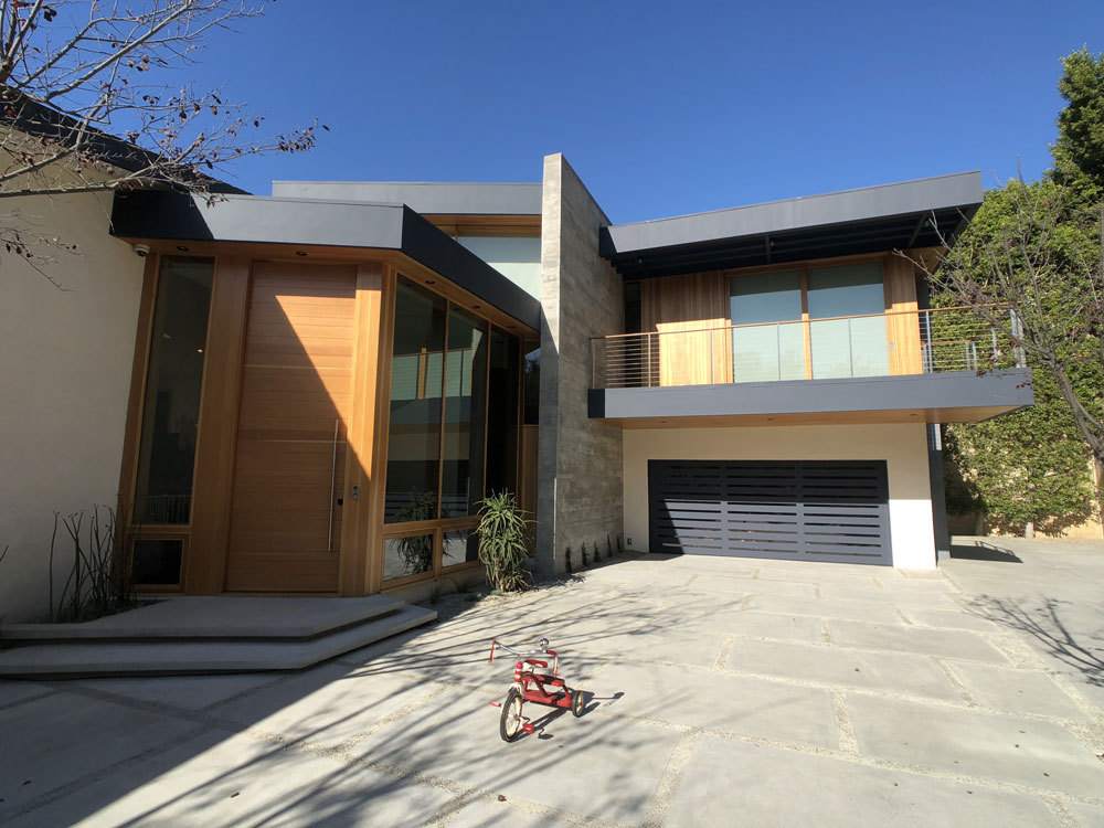 Minizing the prominence of the garage door in the design of a contemporary home